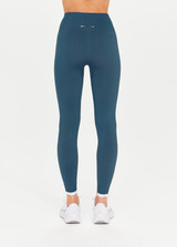 THE UPSIDE Form Seamless 25inch Midi Pant in Pool Blue is a solid knitted seamless mid-rise 7/8 length legging with a contrast white edge stripe at cuffs.