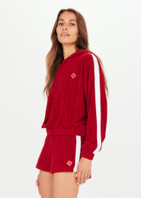 THE UPSIDE Collegiate Gia Crop Hoodie in Red is a cropped hoodie in our monogram TU terry towelling with contrast white tape down sleeves and embroidered arrow badge.