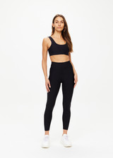 THE UPSIDE women's black Matte Tech 25inch Midi Pant is a mid rise, 7/8 length, matte tech performance legging is made from breathable, quick drying and moisture wicking fabric.