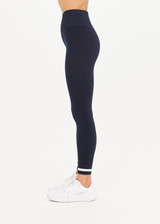 THE UPSIDE womens navy Form Seamless 25in Midi Pant made with Form Seamless fabric features contrast white stripe on ankles, soft ribbed waistband and 25-inch length leg.