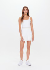 THE UPSIDE womens white scoop neck Peach Lucette panelled mini-dress made with Recycled Peach fabric features a pleated skirt with elastic waistband, built in shorts with pockets, and internal shelf bra.