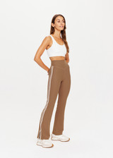 THE UPSIDE womens tan high-rise full length Peached Florence Flare pant made with Peached fabric features white stripe down side seam and split.