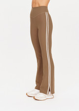 THE UPSIDE womens tan high-rise full length Peached Florence Flare pant made with Peached fabric features white stripe down side seam and split.