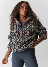 THE UPSIDE womens dark blue abstract pattern Niseko Harlow Pullover made with warm fleece fabric features raglan sleeves, quarter zip, elastic at waist and cuffs, and pink contrasting binds.