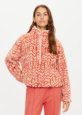 THE UPSIDE womens dark red-brown abstract pattern relaxed Niseko Harlow Pullover made with warm fleece fabrication features printed feathered arrow design, raglan sleeves, quarter zip, and elastic at waist and cuffs.