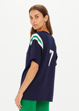 THE UPSIDE women's navy Drifter Seven Tee made in cotton viscose blend knit is a retro-style slim fit tee, featuring a contrasting green and white stripe rib at shoulder, an embroidered “7” on back and ribbed neckline.