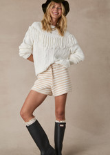 THE UPSIDE women's natural Canyon Roller Knit Short is made from organic cotton. The fitted short features pockets and elastic waistband with drawstring. Designed for lifestyle wear.