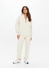 THE UPSIDE women's white organic cotton Hamilton Wren Half Zip Sweater is designed for a regular fit and features a embroidered horseshoe logo. Perfect for everyday.
