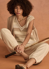 THE UPSIDE women's creme organic cotton Nikko V Neck Knit Vest is designed for an oversized fit and features a deep V neckline. Made for everyday.