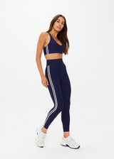 THE UPSIDE women's navy recycled peached Daytona 25 inch Legging is designed for a high-rise supportive fit and features contrast cream binds. Perfect for yoga.