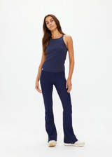 THE UPSIDE women's navy organic cotton Asher Racerback Tank Top is designed for a slim fit and features a racerback shape and high neckline. Ideal for layering & pilates.