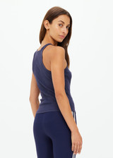 THE UPSIDE women's navy organic cotton Asher Racerback Tank Top is designed for a slim fit and features a racerback shape and high neckline. Ideal for layering & pilates.