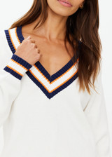 THE UPSIDE women's white organic cotton Josette V Neck Knit Sweater features a striped cable neckline in orange and navy. Made for everyday leisure.