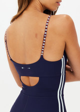 THE UPSIDE women's navy recycled peached Triumph Gia one piece features mint side binds and adjustable straps with half moon cut out at back. Made for pilates.
