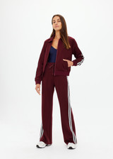 THE UPSIDE women's merlot Vitesse Pari Zip Jacket is a zip through sport jacket in a slinky fabrication with mesh stripes down sides in Mint. Made for lifestyle.