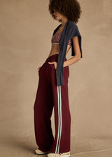 THE UPSIDE women's merlot Vitesse Marine Wide Leg Pant is a high rise fit and features a elasticated waistband, drawcord and side seam pockets in slinky fabrication. Made for lifestyle.