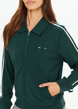 THE UPSIDE women's green Cobra Pari Zip Jacket is a true-to-size fit in a soft fabrication and features knitted stripes down sleeves. Made for everyday leisure.