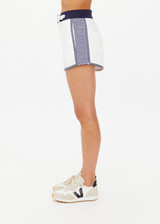 THE UPSIDE women's white organic cotton Racer Short features a navy waistband with a built-in belt detail and back welt pockets. Made for everyday leisure.