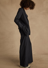 THE UPSIDE women's navy pinstripe merino Wool Mira Wide Leg Pant features a flat waistband with belt loops and side pockets.