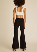 THE UPSIDE women's black classic Joyela Flare Pant is made from a lenzing viscose blend and features an embroidered arrow at the black.