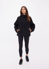 THE UPSIDE women's black Harlow Fleece Pullover offers a relaxed fit made from recycled warm fleece fabric and features zip pockets and an elastic at waist and cuffs to keep warmth in. Made for lifestyle.