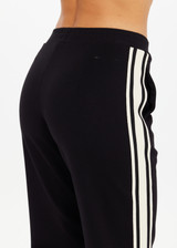 THE UPSIDE women's black Petra Flare Pant is made from soft suiting fabric and features elasticated waistband, side pockets and contrast cream stripes down side seams. Made for lifestyle.