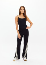 THE UPSIDE women's black Petra Flare Pant is made from soft suiting fabric and features elasticated waistband, side pockets and contrast cream stripes down side seams. Made for lifestyle.