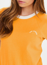 THE UPSIDE women’s yellow organic cotton Daisy Salome Tee has a regular fit with a soft ribbed neckline and cream contrast panels on the shoulders. Made for lifestyle.