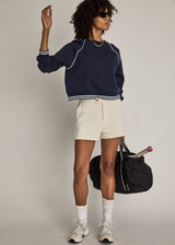 THE UPSIDE women’s cream cotton Penny Tilly Short is a low-rise style with a structured waistband and branded tortoiseshell button closure. Made for everyday wear.