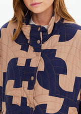 THE UPSIDE women's organic cotton Mirage Carmen Quilted Jacket is an oversized fit and features a zip opening and pockets in our navy and tan geometric print. Made for lifestyle.