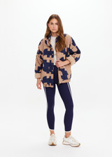 THE UPSIDE women's organic cotton Mirage Carmen Quilted Jacket is an oversized fit and features a zip opening and pockets in our navy and tan geometric print. Made for lifestyle.