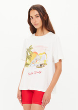 THE UPSIDE women's organic cotton creme Feeling Lucky Jodhi Tee features a classic shape and Feeling Lucky graphic printed on the front chest. Made for everyday wear.
