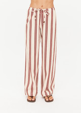 THE UPSIDE women's stripe organic cotton Baja Charli Drawstring Pant is low-rise with a straight leg, soft elastic waistband, and wooden bead ends on drawcord. Made for lifestyle.