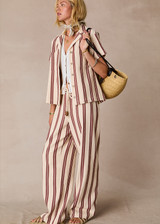 THE UPSIDE women's stripe organic cotton Baja Charli Drawstring Pant is low-rise with a straight leg, soft elastic waistband, and wooden bead ends on drawcord. Made for lifestyle.