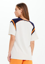 THE UPSIDE women's cream cotton Elixir Seven Tee is designed for a relaxed fit and features orange and navy stripes on neckline and shoulders. Made for everyday wear.
