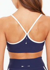 THE UPSIDE women’s navy recycled peached Samara Bowie Bra offers a soft & supportive fit and features a scooped front neckline with crossback and removable cups. Made for yoga & pilates.