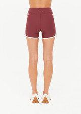THE UPSIDE women’s red recycled peached Samara 3.5inch Spin Short offers a soft & supportive fit and features side pockets and contrast cream stripes. Made for pilates.