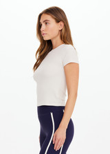 THE UPSIDE women’s cream Shelter Fitted Tee is designed for a soft & comfortable fit and features an embroidered arrow logo at the back of neck. The perfect everyday tee.