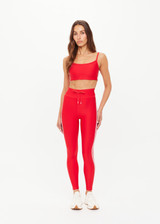 THE UPSIDE women's red eco tech Oxford Hutton Scoop Bra offers support and comfort with cream side stripes, adjustable straps, removable cups, and shelf bra. Made for high impact.