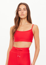 THE UPSIDE women's red eco tech Oxford Hutton Scoop Bra offers support and comfort with cream side stripes, adjustable straps, removable cups, and shelf bra. Made for high impact.