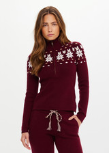 THE UPSIDE women’s maroon organic cotton Le Ski Blanche Half Zip features a zip through opening and a knitted snowflake design across chest and back. Designed for Après-ski and winter wear.