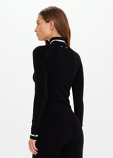 THE UPSIDE women’s black merino Wool Seamless Base Quarter Zip offers a soft & comfortable fit and features white striped ribbing on cuffs and collar. Designed for Après-ski and winter wear.