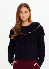 THE UPSIDE women’s navy Clara Tassle Knit Sweater is a relaxed, cable knit design featuring knotted tassels on front and back. Designed for Après-ski and winter wear.
