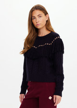 THE UPSIDE women’s navy Clara Tassle Knit Sweater is a relaxed, cable knit design featuring knotted tassels on front and back. Designed for Après-ski and winter wear.