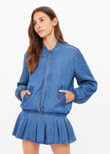 THE UPSIDE women’s blue denim Lykke Lexi Bomber Jacket, in a soft chambray fabrication, is made for a relaxed fit. This zip-through jacket features front pockets with branded tortoiseshell buttons.