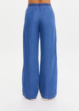 THE UPSIDE women’s blue Lykke Juliet Pant in soft chambray features a low-rise fit, split hem, and contrasting mesh knit side stripe. The perfect travel pant.