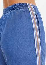 THE UPSIDE women’s blue Lykke Juliet Pant in soft chambray features a low-rise fit, split hem, and contrasting mesh knit side stripe. The perfect travel pant.