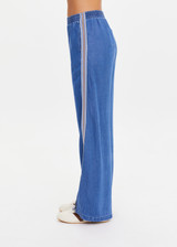 THE UPSIDE women’s blue Lykke Juliet Pant in soft chambray features a low-rise fit, split hem, and contrasting mesh knit side stripe. The perfect travel pant.