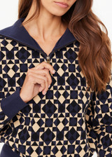 THE UPSIDE women’s navy organic cotton Cosmo Kairo Half Zip Knit is a relaxed fit and features a half zip front and beige knitted stripes down sleeves. Made for everyday leisure.