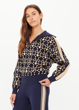 THE UPSIDE women’s navy organic cotton Cosmo Kairo Half Zip Knit is a relaxed fit and features a half zip front and beige knitted stripes down sleeves. Made for everyday leisure.